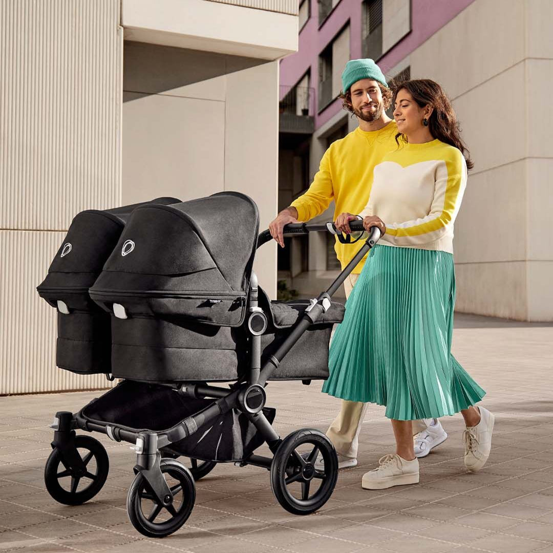 Parents walking with double prams