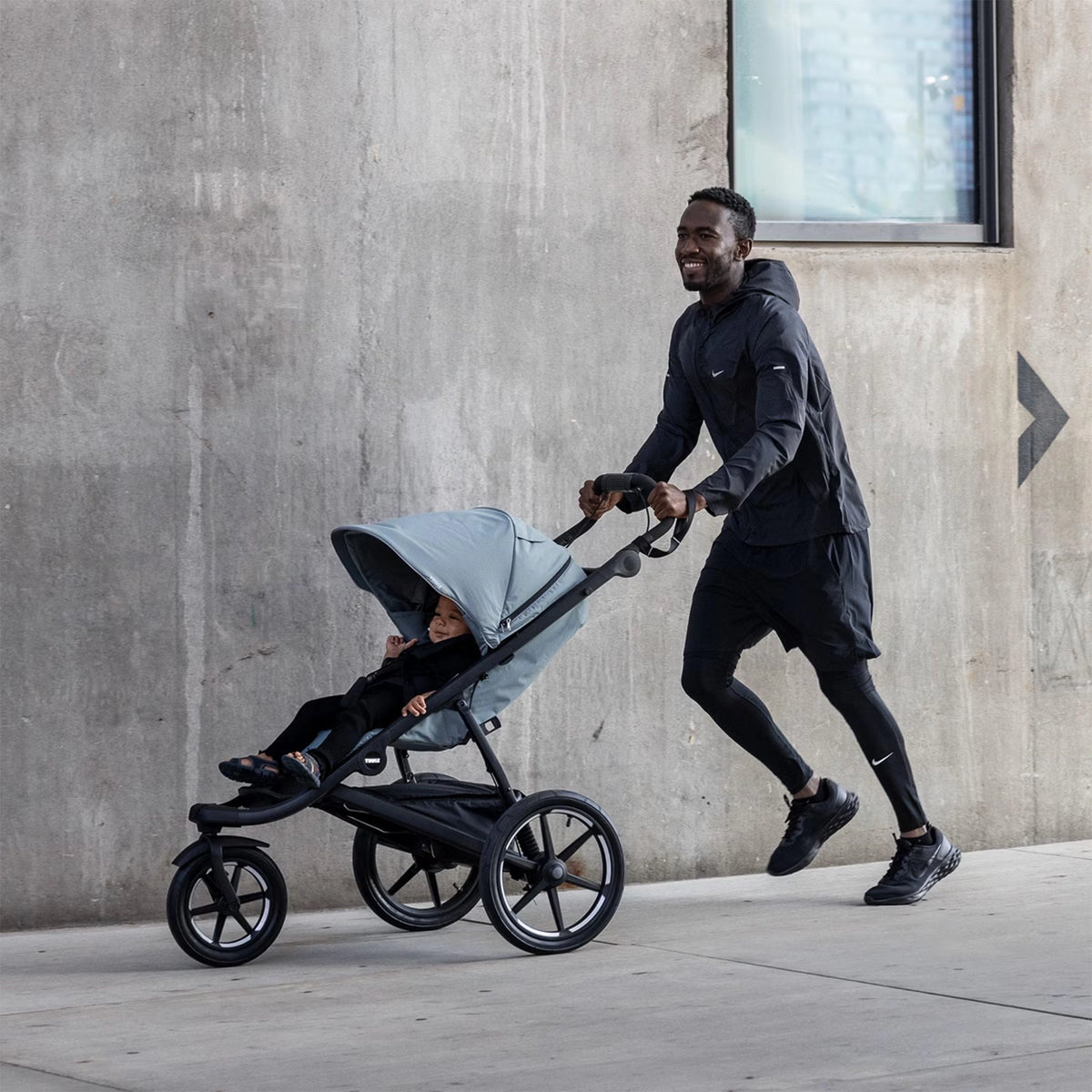 Parent running with a running pram