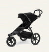 A black Thule Urban Glide 3-wheel stroller with a compact fold feature, designed for use on various terrains. Thule Urban Glide rental on Baboodle