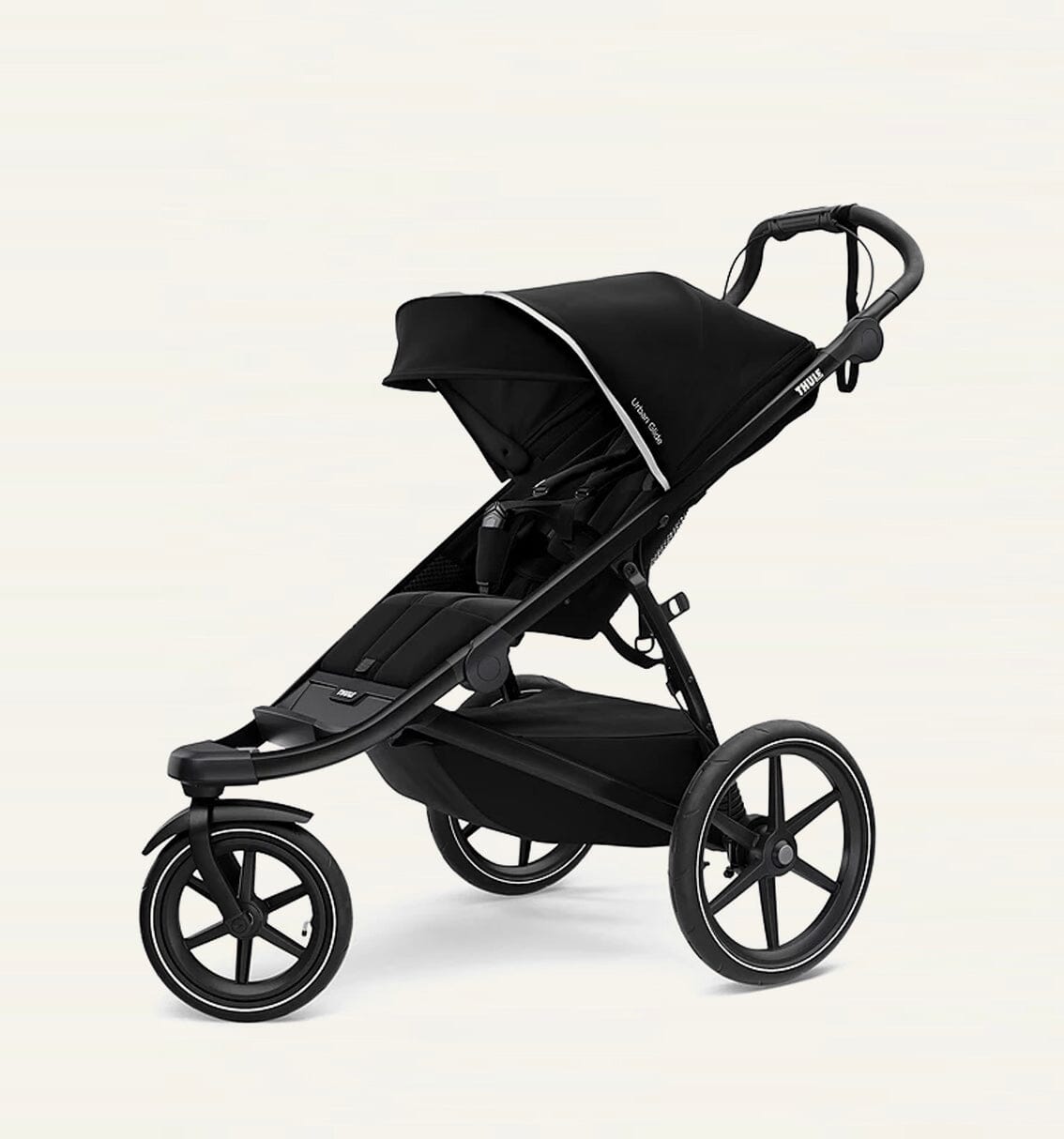 A black Thule Urban Glide 3-wheel stroller with a compact fold feature, designed for use on various terrains. Thule Urban Glide rental on Baboodle