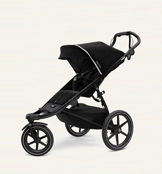 A black Thule Urban Glide 3-wheel stroller with a compact fold feature, designed for use on various terrains. Thule Urban Glide rental on Baboodle